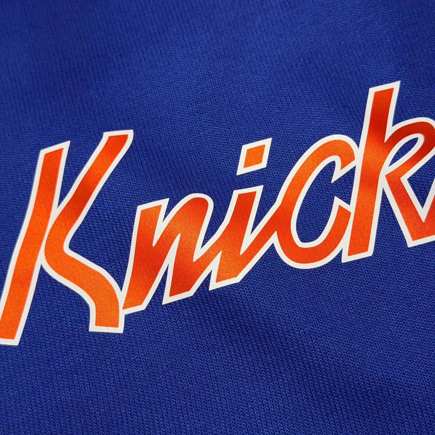 Close-up of 'Knick' text on a blue background
