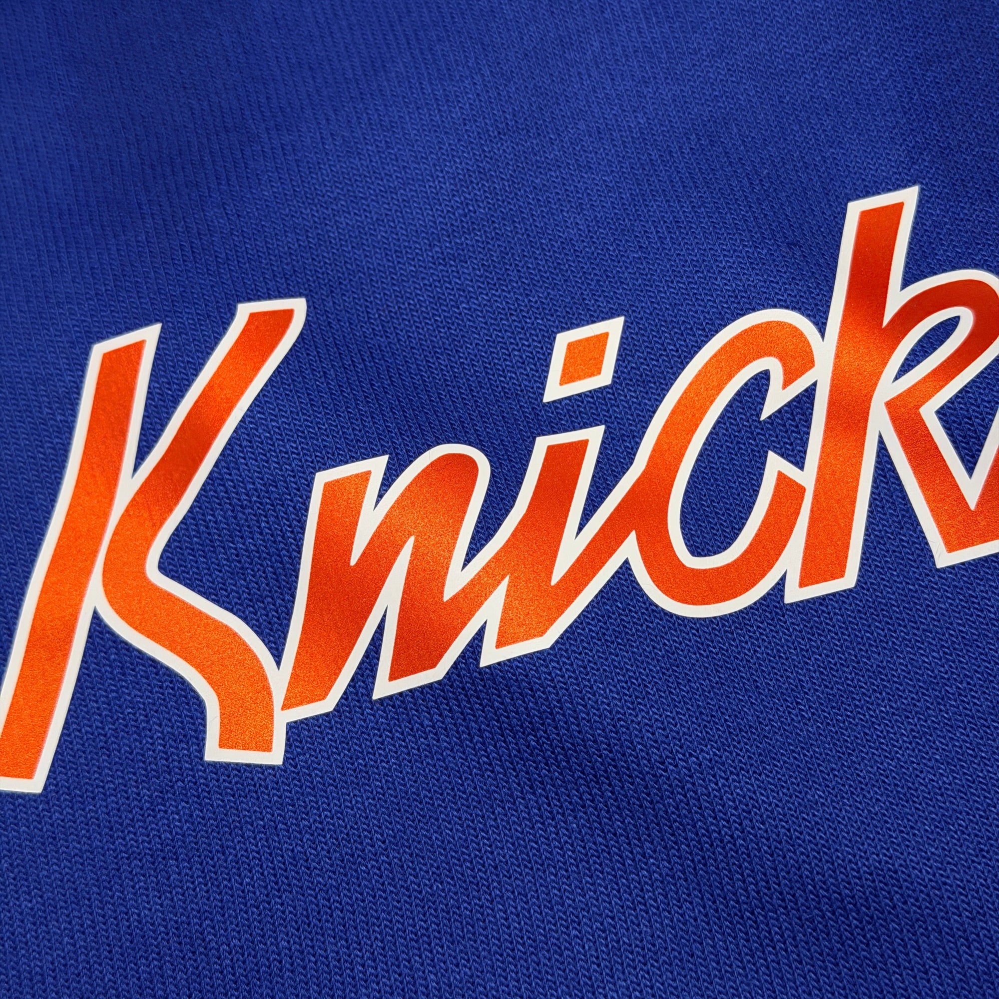 Close-up of 'Knick' text on a blue background